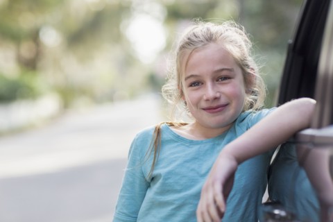 Caucasian girl leaning on car
