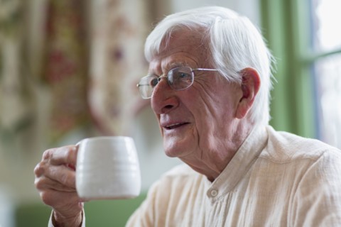 Older Caucasian man drinking coffee