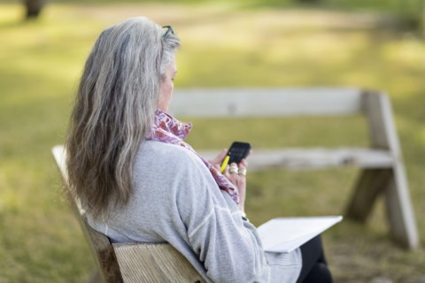 Older Caucasian woman using cell phone outdoors