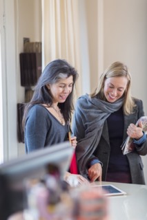 Small business owners using digital tablet in store