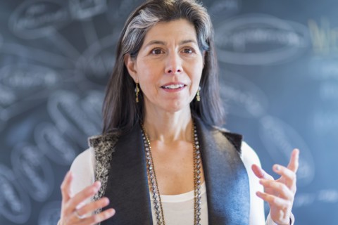 Hispanic businesswoman talking in office