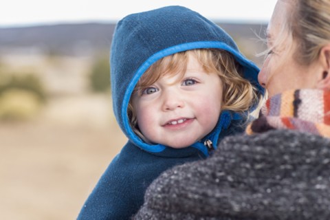 Caucasian mother carrying baby boy
