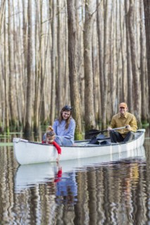Family sitting together in canoe on river