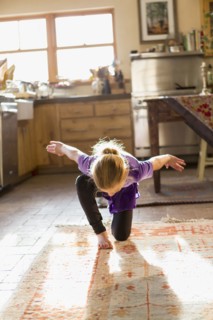 Caucasian girl dancing in kitchen