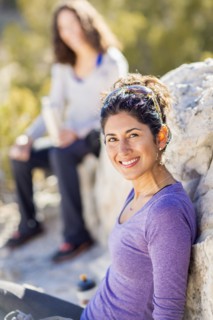 Hiker smiling on rocky hillside