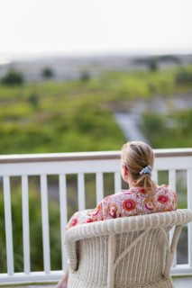 Caucasian woman admiring view from porch