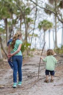 Caucasian brother and sister walking on dirt path
