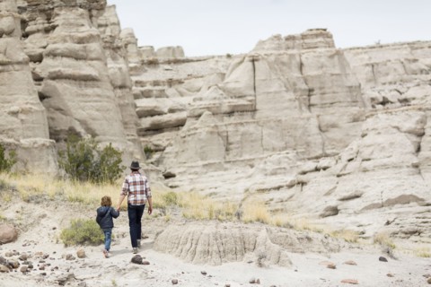 Father and son exploring desert rock formations