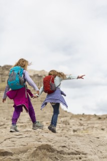 Caucasian girls exploring desert rock formations