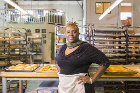 Black baker standing in bakery kitchen