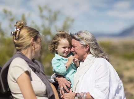 Multi-generation Caucasian family hugging outdoors