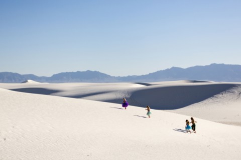 Girls walking on desert sand dunes