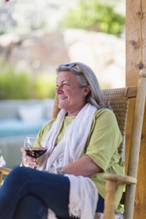 Caucasian woman drinking wine on porch
