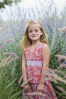 Caucasian girl smiling in tall grass