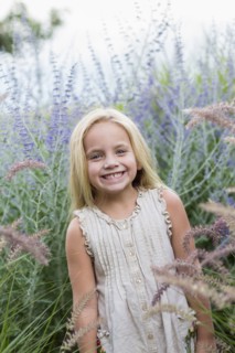 Caucasian girl standing in tall flowers
