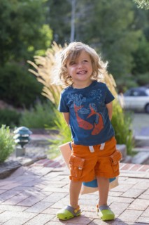 Caucasian toddler hiding gift behind back