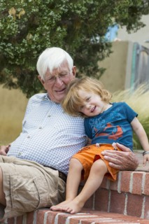 Caucasian grandfather and grandson hugging outdoors