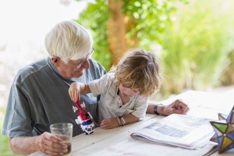Caucasian grandfather and grandson playing with toy helicopter