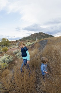 Caucasian children exploring hillside