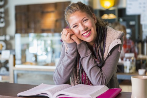 Mixed race student studying in cafe