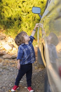 Caucasian boy opening car door