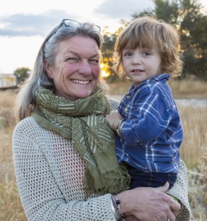 Caucasian grandmother holding grandson outdoors