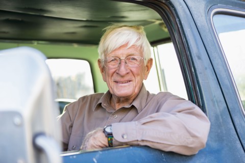Older Caucasian man sitting in truck