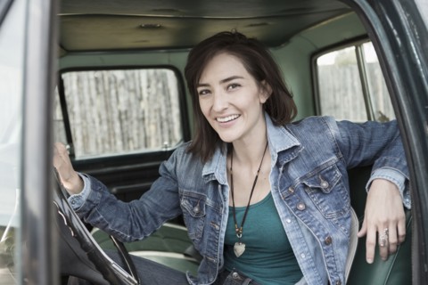 Hispanic woman sitting in truck