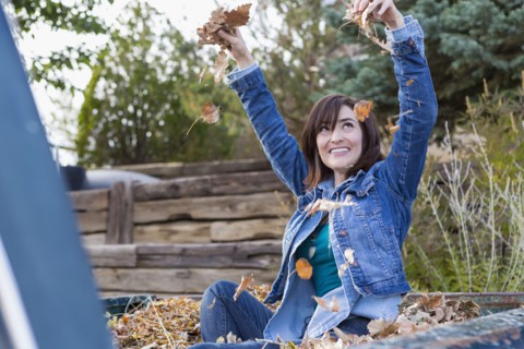 Hispanic woman playing in truck bed