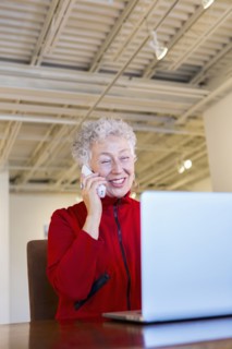 Older mixed race woman working in art gallery