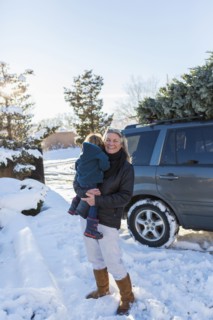 Caucasian mother holding son in snow