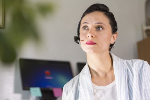 Businesswoman wearing headset in office