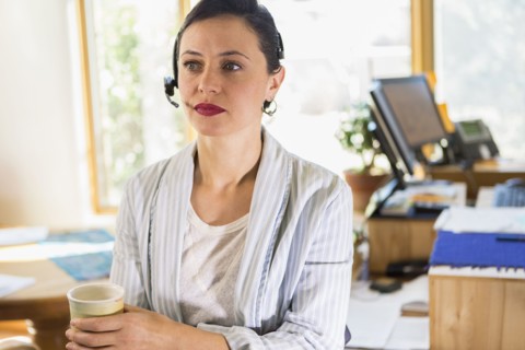 Businesswoman wearing headset in office