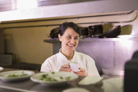 Caucasian chef smiling in restaurant kitchen