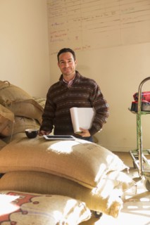 Hispanic entrepreneur using digital tablet in store