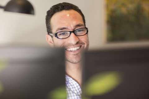 Hispanic businessman using computer in office