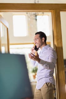 Hispanic businessman talking on telephone in office
