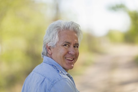 Caucasian man looking over shoulder