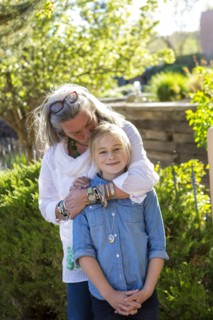 Smiling Caucasian grandmother hugging granddaughter