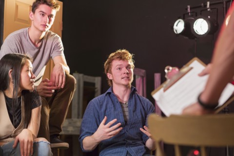 Student talking to teacher in theater class