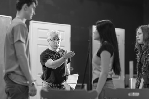 Teacher talking to students in theater class