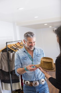 Woman showing hat to man in store