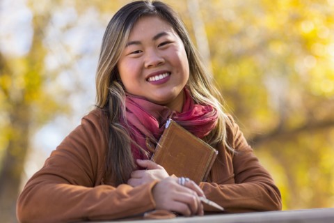 Portrait of smiling Asian woman in autumn