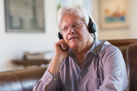 Caucasian man listening to headphones