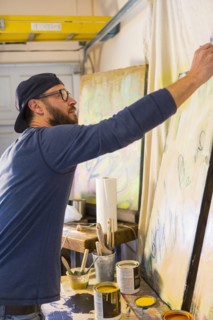 Caucasian man creating paintings