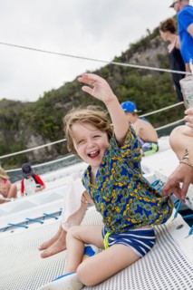 Caucasian boy waving arm on boat