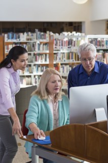 Older people using computer in library