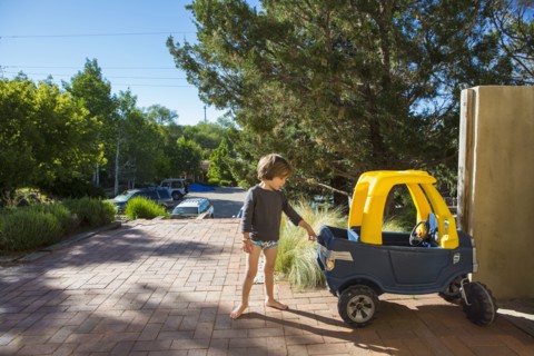 Caucasian boy playing with toy car