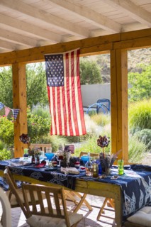 American flag hanging on patio near table