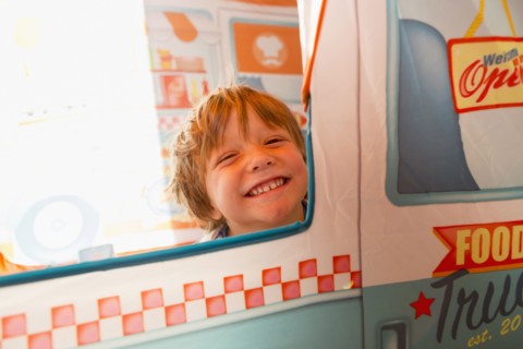 Portrait of smiling Caucasian boy in window